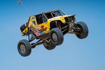 Off road race car flying through the air after taking of from a jump. Moab 4x4 Expo