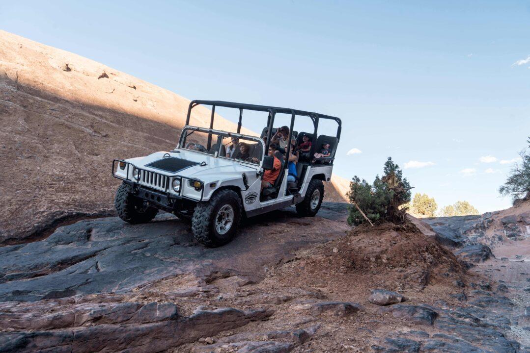 White hummer climbing the rocks on Hell's Revenge