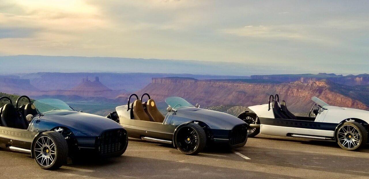 3 of our Vanderhall Rentals parked overlooking Castle Valley from a high cliff