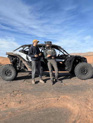 Ethan posing with a machine on the Hell's Revenge trail 