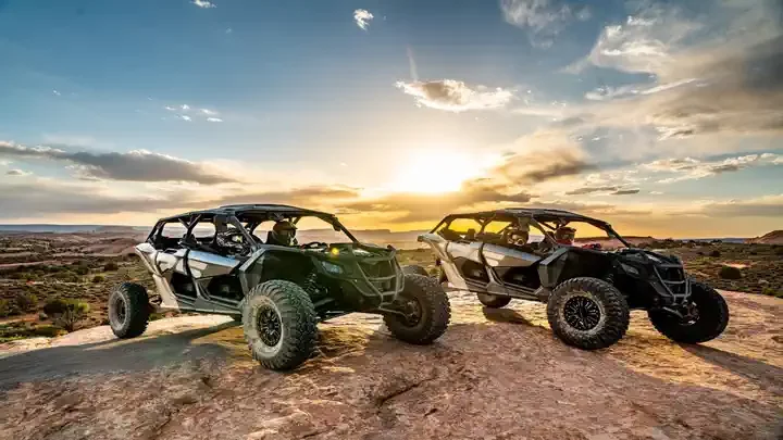 Two Can-Am Maverick X3 4-seaters at sunset on Hell's Revenge